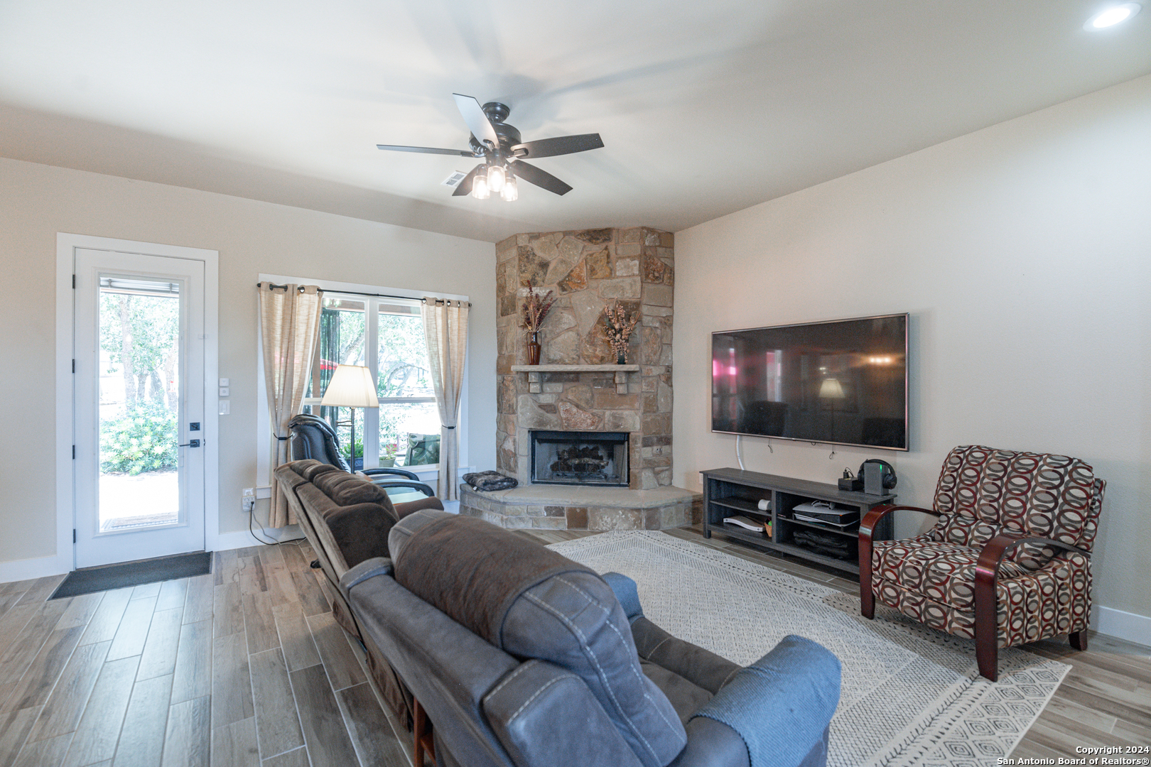 924 Rhinestone Canyon Lake, TX 78133 - Photo 13 of 41 a living room with fireplace furniture and a flat screen tv