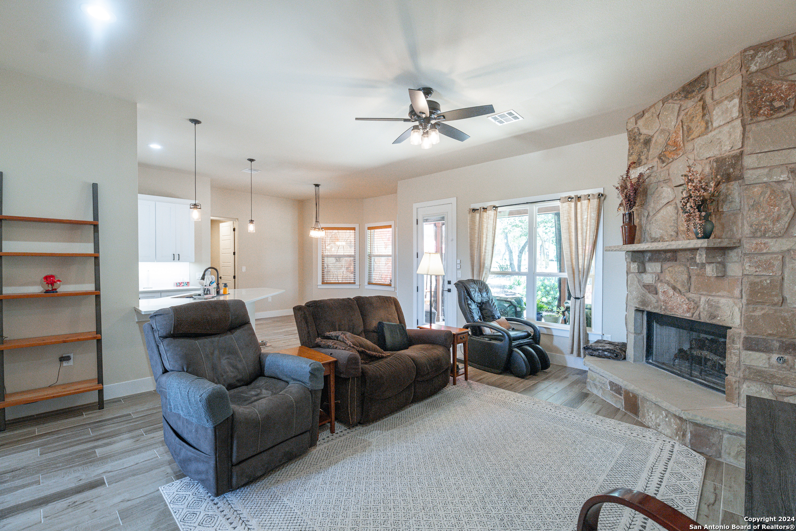 924 Rhinestone Canyon Lake, TX 78133 - Photo 15 of 41 a living room with furniture and a fireplace