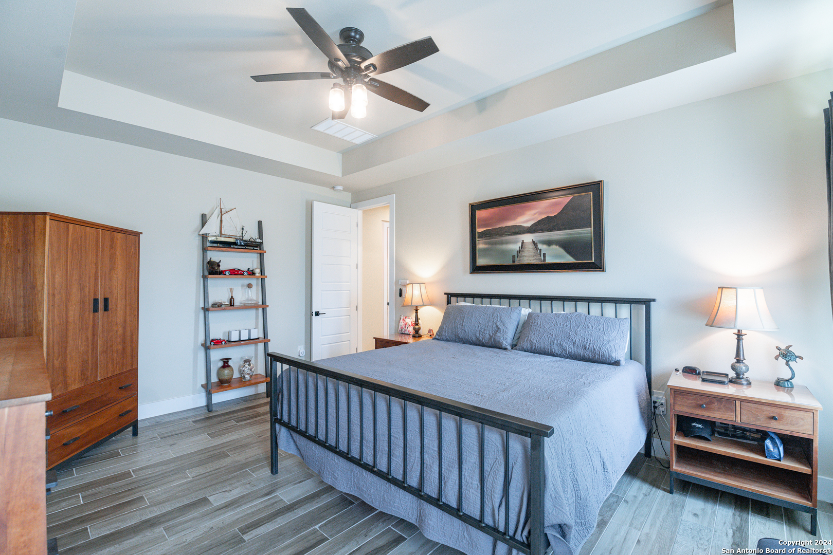 924 Rhinestone Canyon Lake, TX 78133 - Photo 17 of 41 a bedroom with furniture and a chandelier