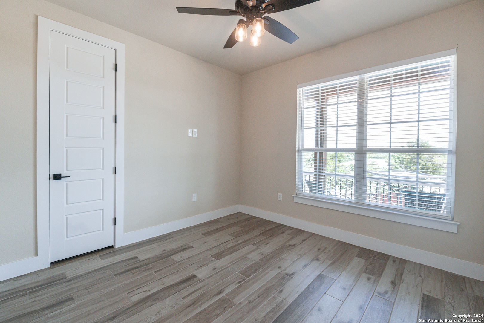 924 Rhinestone Canyon Lake, TX 78133 - Photo 21 of 41 wooden floor in an empty room with a window