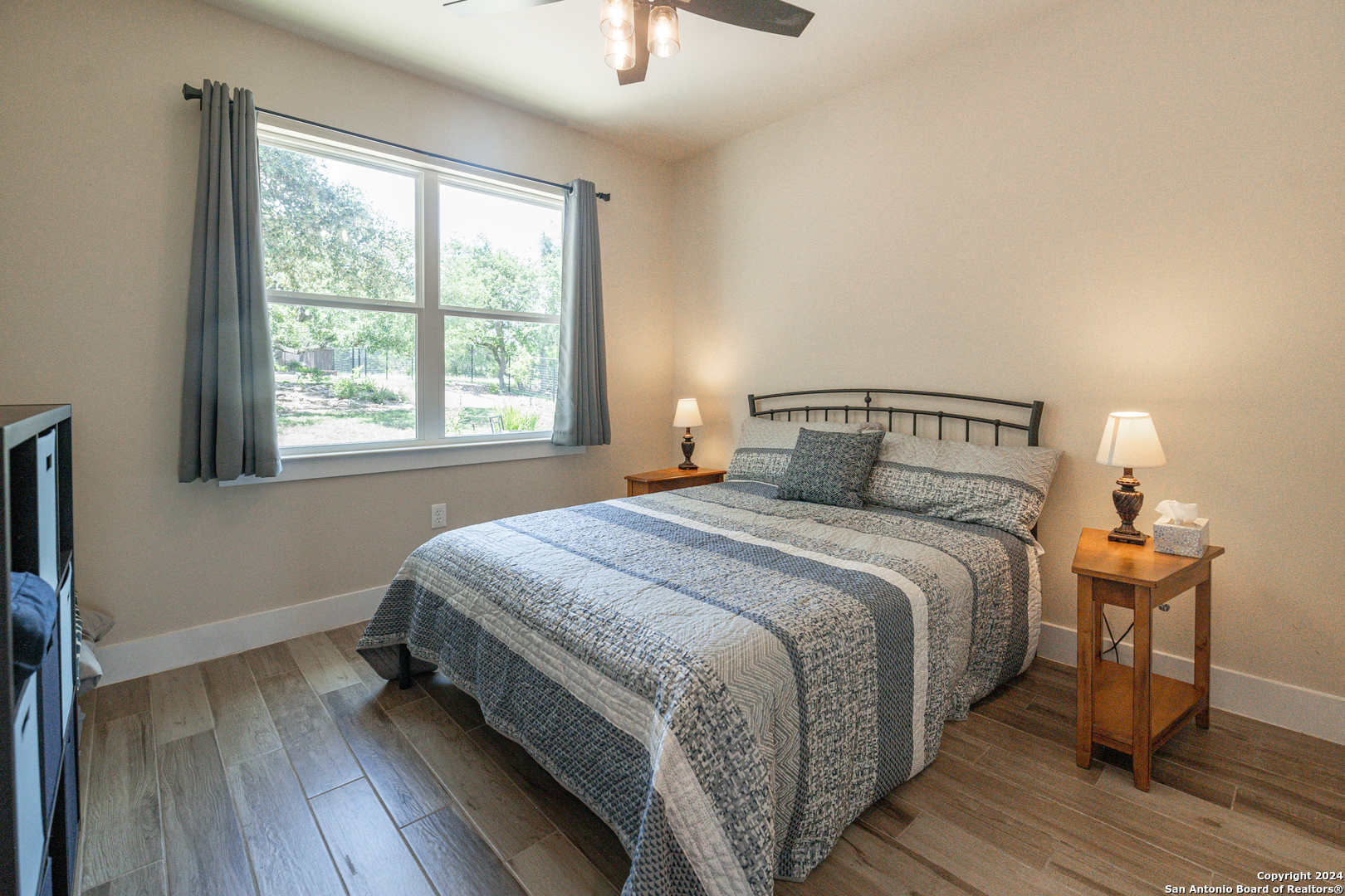 924 Rhinestone Canyon Lake, TX 78133 - Photo 26 of 41 a bedroom with a bed and wooden floor