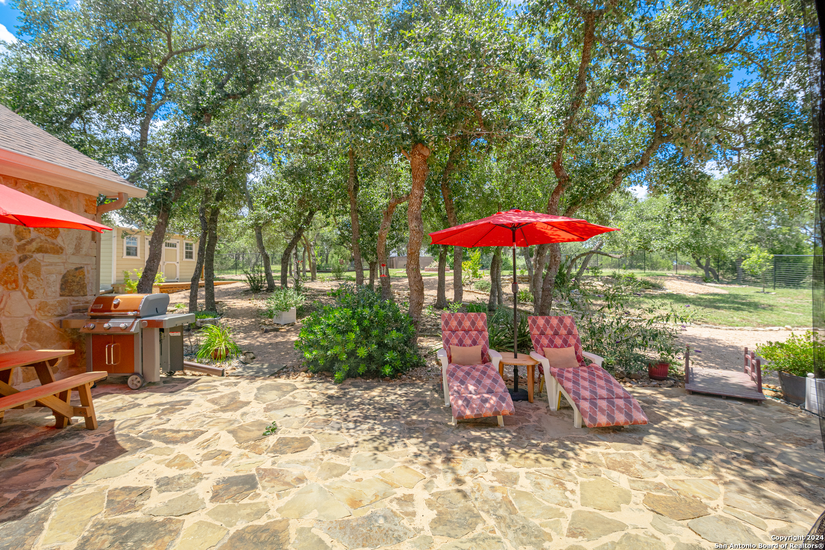924 Rhinestone Canyon Lake, TX 78133 - Photo 29 of 41 a view of a patio with a table and chairs under an umbrella
