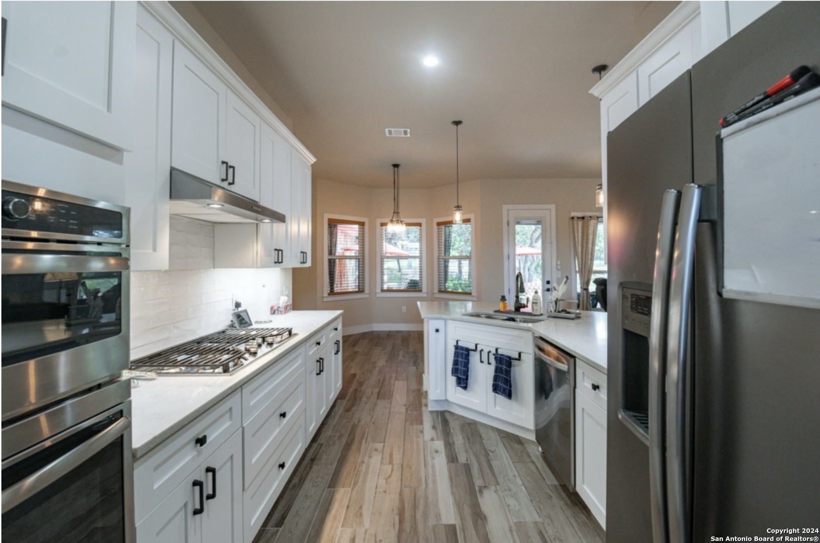 924 Rhinestone Canyon Lake, TX 78133 - Photo 10 of 41 a kitchen with stainless steel appliances granite countertop a stove a refrigerator and a stove