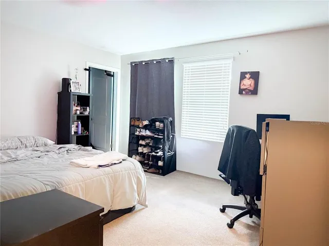 a bedroom with a bed and a chair