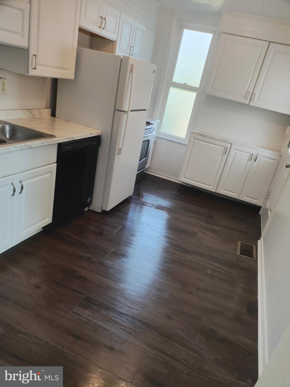 616 George Street Hagerstown, MD 21740 - Photo 4 of 16 a kitchen with wooden floors and white appliances