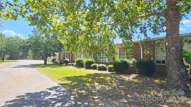 a view of a house with swimming pool and sitting area
