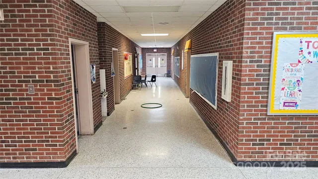 a living room with furniture and a refrigerator