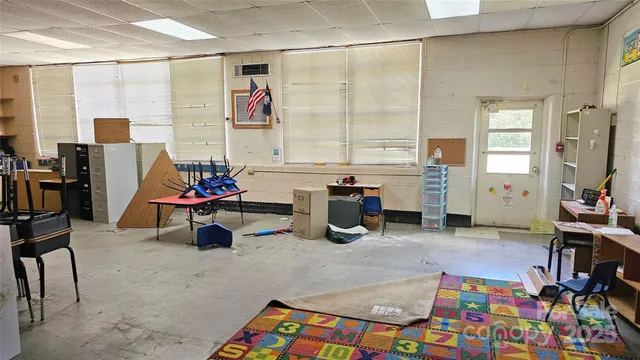 a view of a livingroom with workspace and windows