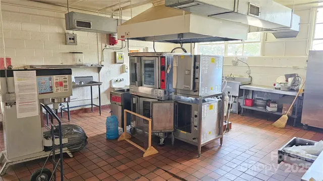 a utility room with lots of clutter and cabinets
