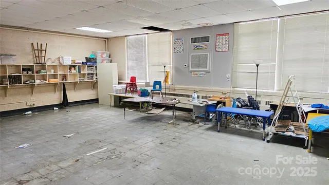 a living room with furniture gym equipment and a large window