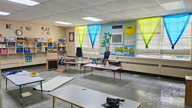 a bedroom with bed and a large window