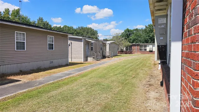 a backyard of a house with table and chairs