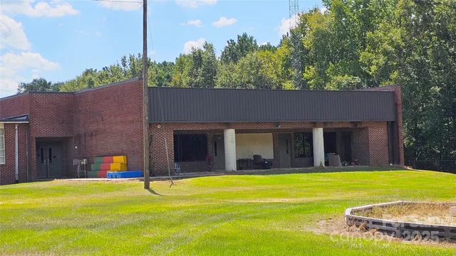 a swimming pool with outdoor seating and yard