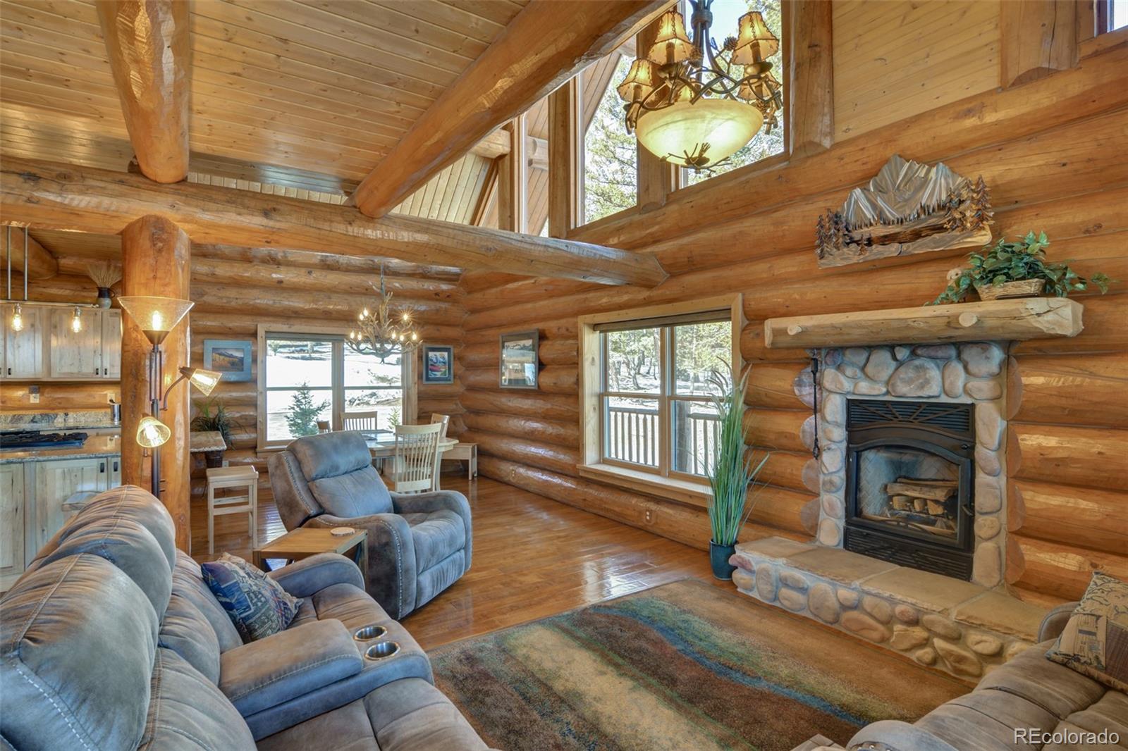 2120 Blacksmith Road Hartsel, CO 80449 - Photo 16 of 50 a living room with furniture a fireplace and a table