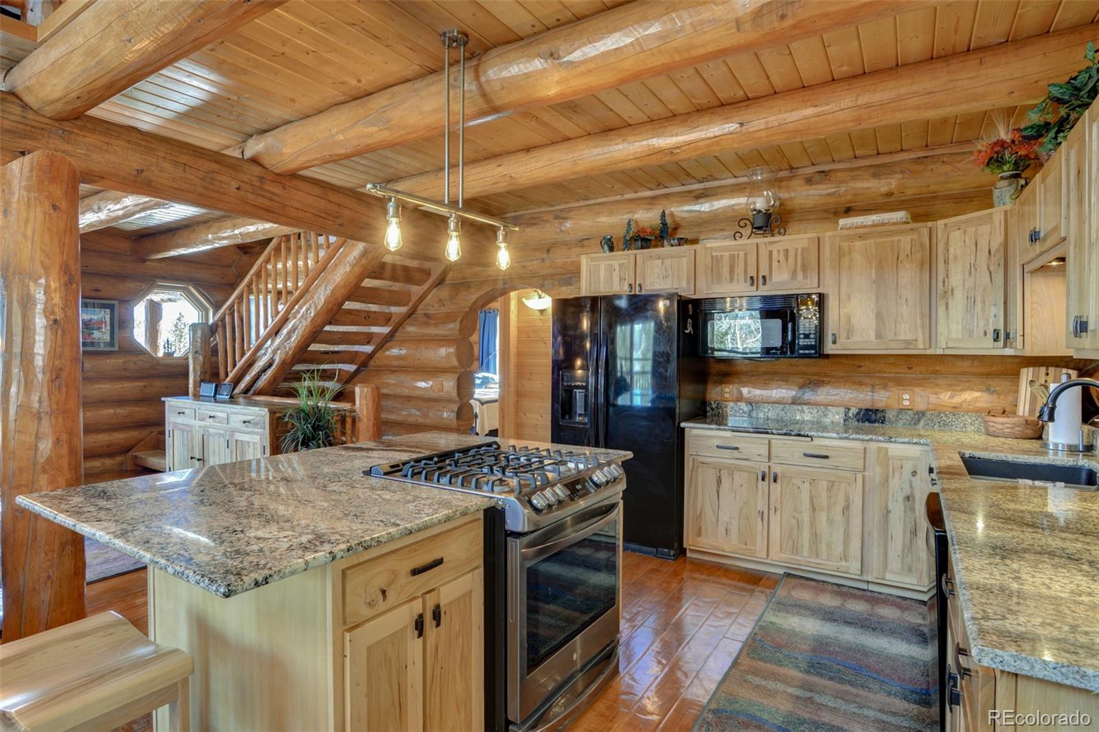 2120 Blacksmith Road Hartsel, CO 80449 - Photo 24 of 50 a kitchen with stainless steel appliances granite countertop a sink a stove and cabinets