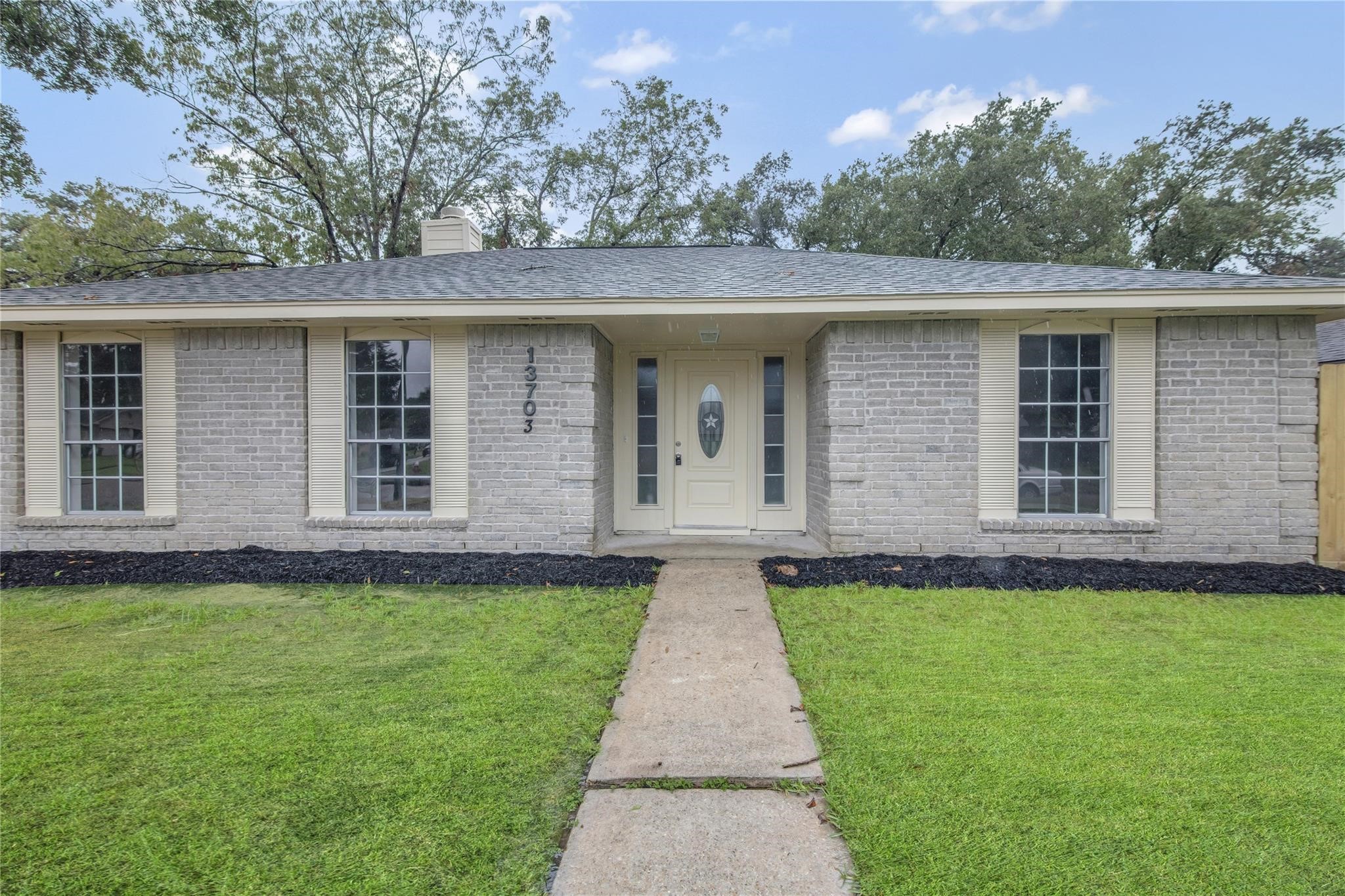 a front view of a house with a garden