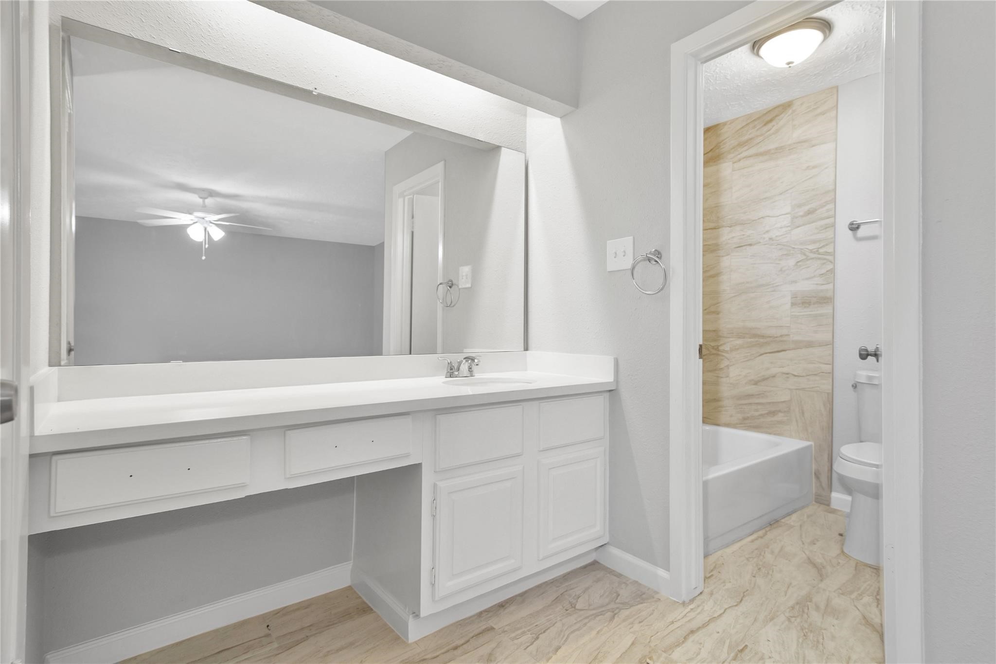 13703 Cologne Drive Houston, TX 77065 - Photo 24 of 32 a bathroom with a double vanity sink and a mirror