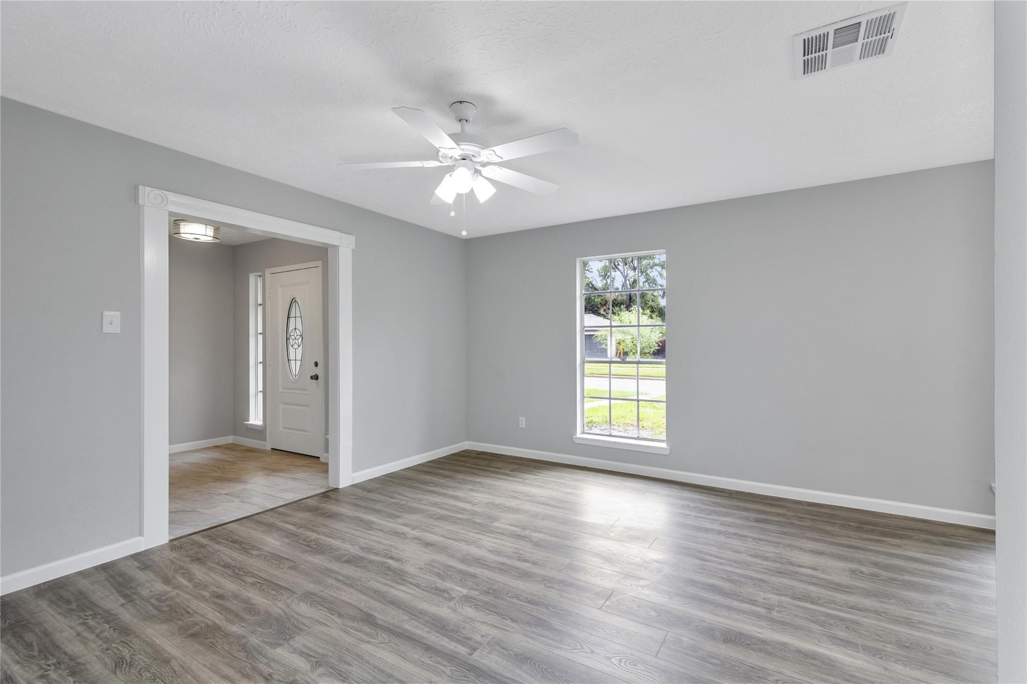 13703 Cologne Drive Houston, TX 77065 - Photo 7 of 32 a view of an empty room with wooden floor and a window