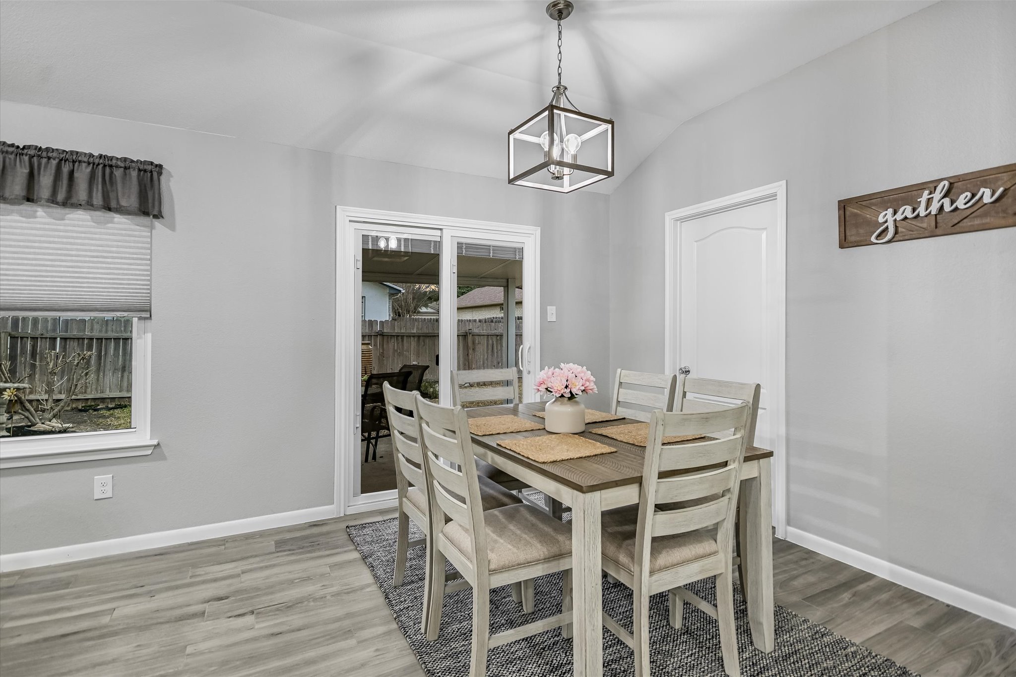 1312 Pigeon View Street Round Rock, TX 78665 - Photo 13 of 30 Dining area featuring vaulted ceiling, light wood-type flooring, and a chandelier