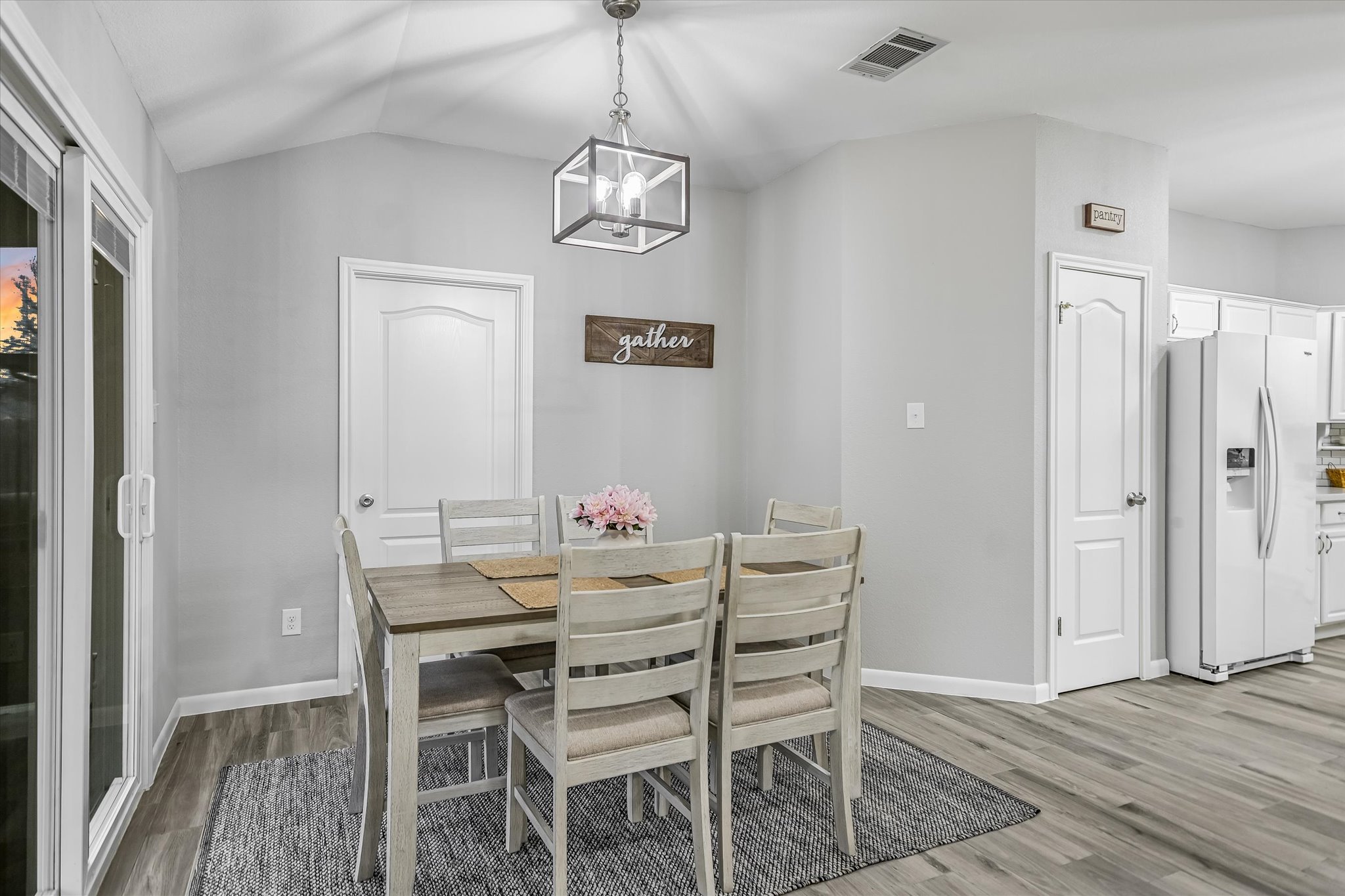 1312 Pigeon View Street Round Rock, TX 78665 - Photo 14 of 30 Dining room with vaulted ceiling, a chandelier, and light wood-style flooring