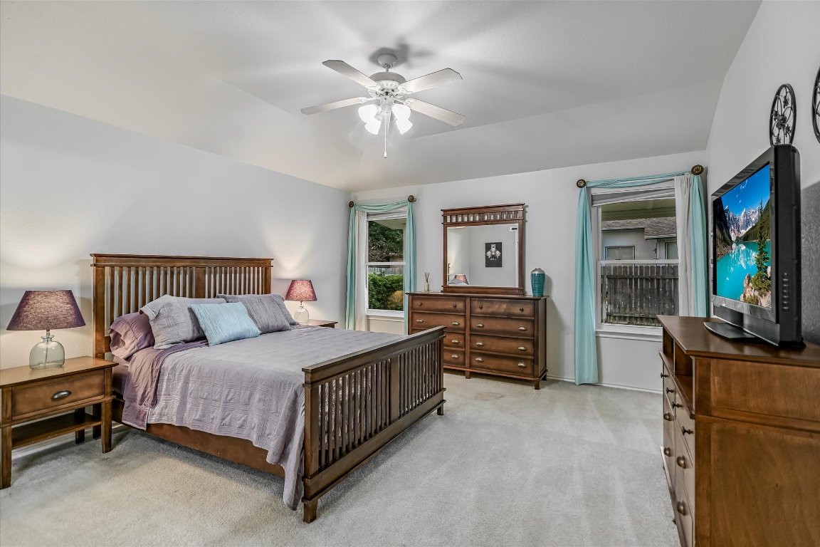 1312 Pigeon View Street Round Rock, TX 78665 - Photo 18 of 30 a bedroom with a bed and a flat screen tv