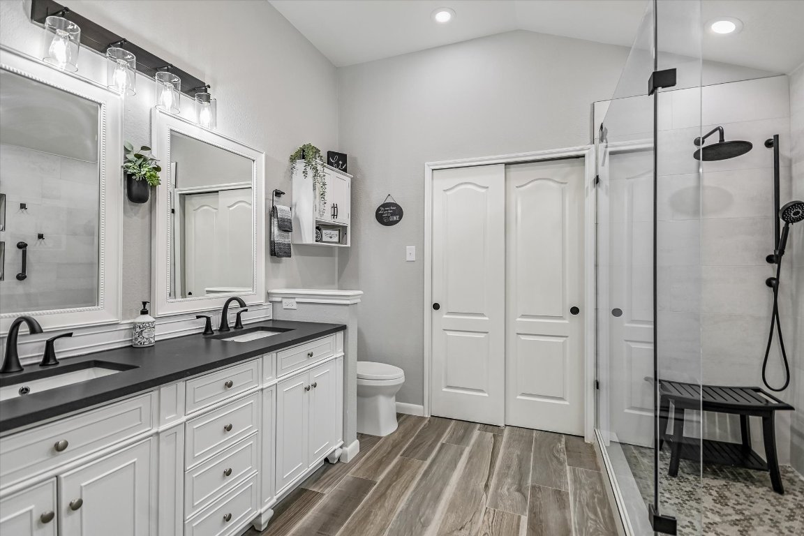 1312 Pigeon View Street Round Rock, TX 78665 - Photo 20 of 30 a spacious bathroom with a double vanity sink a mirror a toilet and a shower