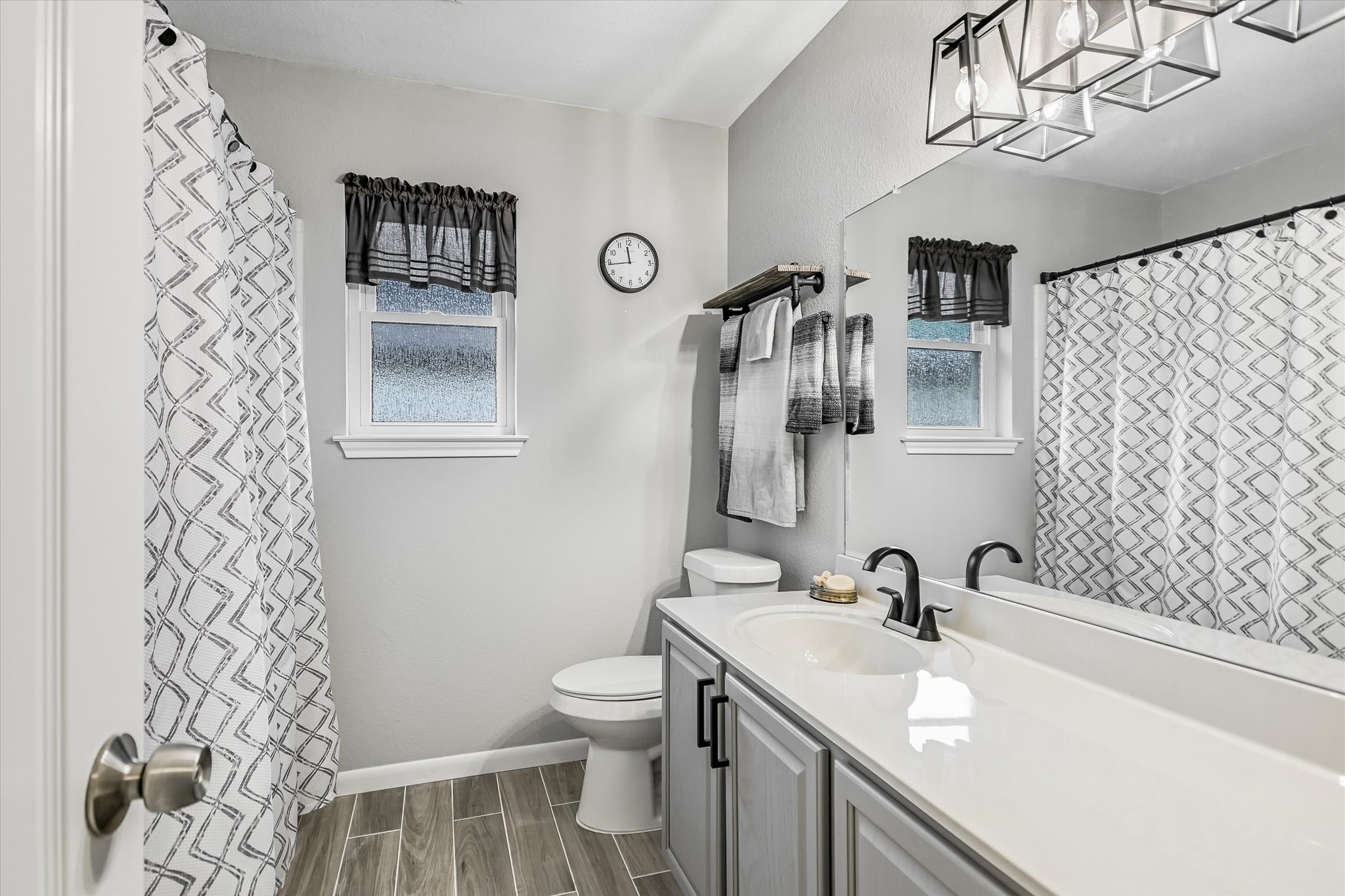 1312 Pigeon View Street Round Rock, TX 78665 - Photo 23 of 30 Full bathroom featuring wood finish floors, a shower with shower curtain, vanity, and healthy amount of natural light