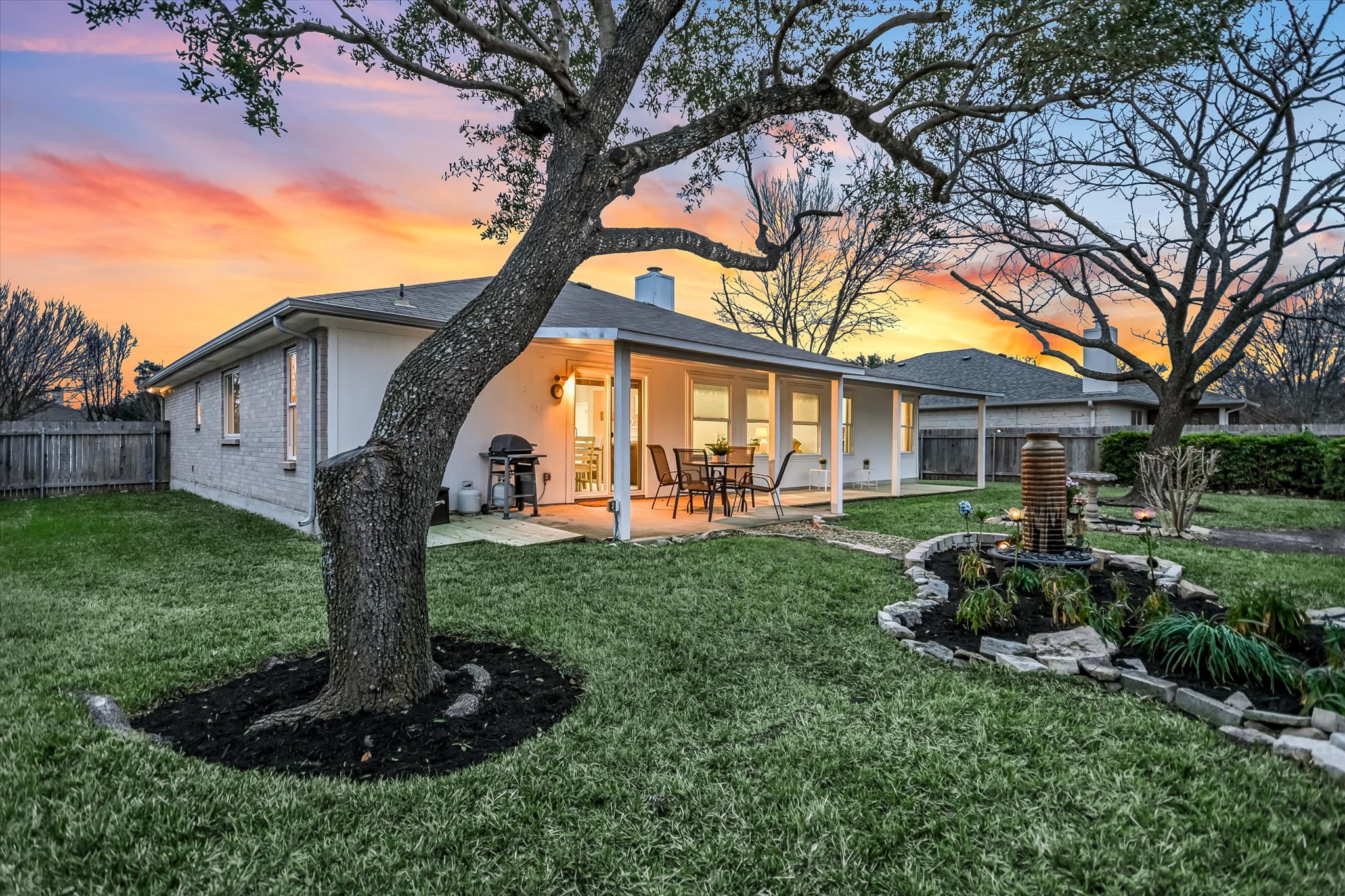 1312 Pigeon View Street Round Rock, TX 78665 - Photo 29 of 30 Back of house featuring a fenced backyard, a patio area, brick siding, and stucco siding