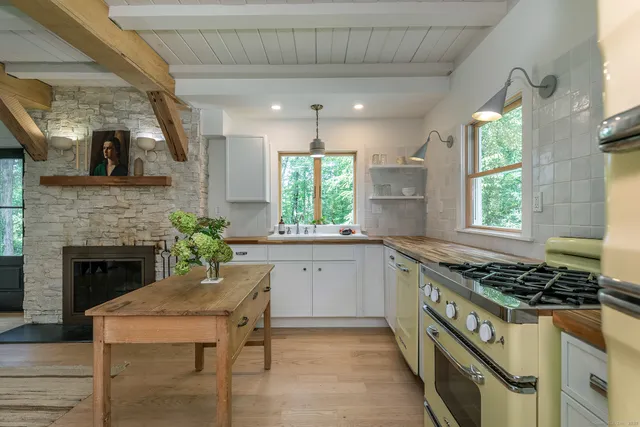 a kitchen with a sink window and cabinets