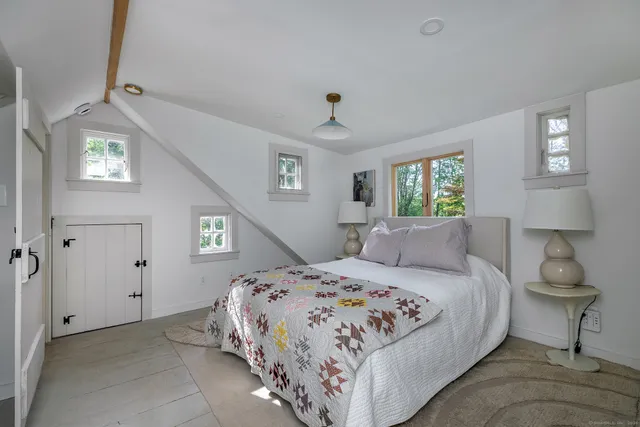 a bathroom with a granite countertop sink a mirror and shower