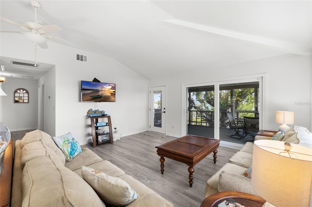 9776 Little Gasparilla Boca Grande, FL 33921 - Photo 17 of 52 a living room with furniture a table and a large window