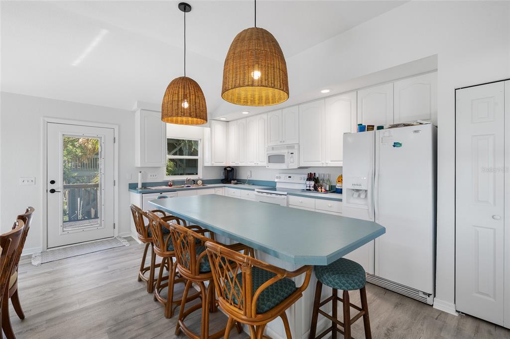 9776 Little Gasparilla Boca Grande, FL 33921 - Photo 21 of 52 a large kitchen with a table and chairs