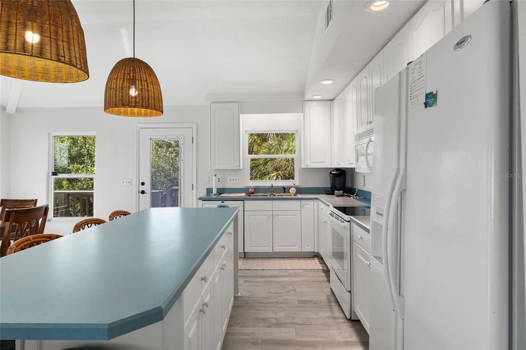 9776 Little Gasparilla Boca Grande, FL 33921 - Photo 22 of 52 a kitchen with stainless steel appliances granite countertop a sink a window and cabinets
