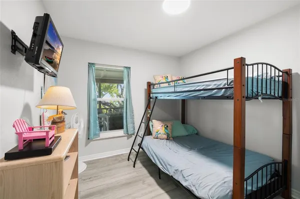 a bedroom with a bed and a chandelier