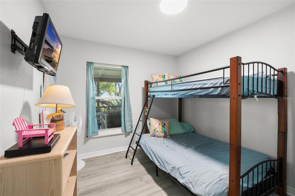 9776 Little Gasparilla Boca Grande, FL 33921 - Photo 26 of 52 a bedroom with a bed and a chandelier