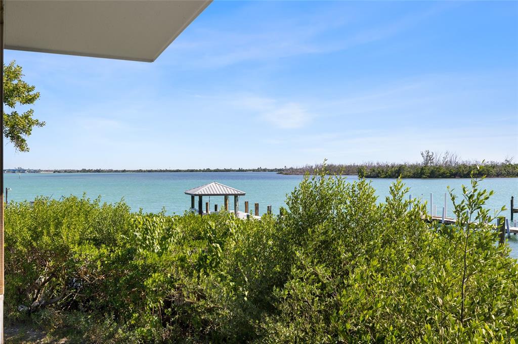 9776 Little Gasparilla Boca Grande, FL 33921 - Photo 28 of 52 a view of a large body of water with a building in the background