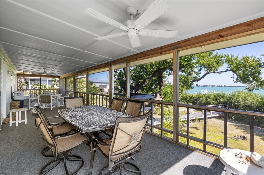 9776 Little Gasparilla Boca Grande, FL 33921 - Photo 31 of 52 a view of a patio with a table chairs and a table