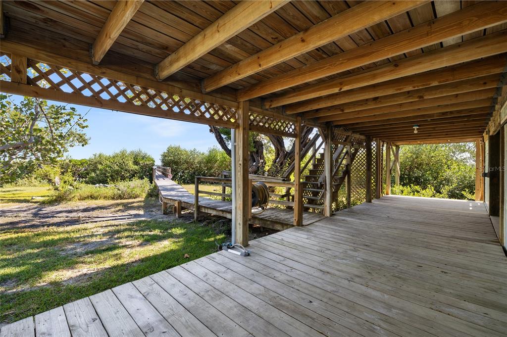 9776 Little Gasparilla Boca Grande, FL 33921 - Photo 37 of 52 a view of a patio with wooden floor