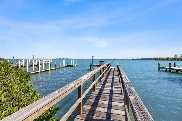 a view of a balcony with two chairs and wooden floor