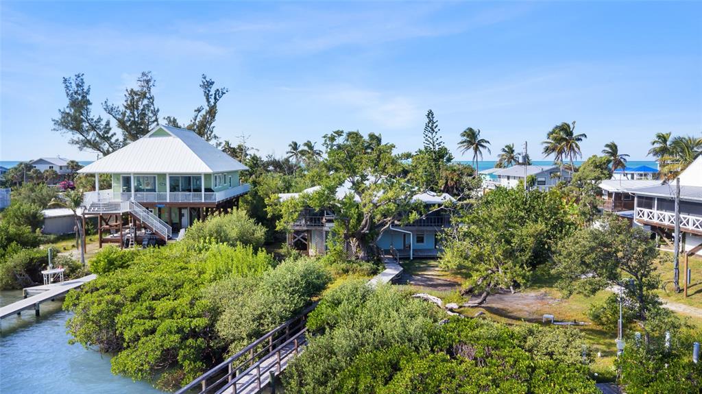 9776 Little Gasparilla Boca Grande, FL 33921 - Photo 51 of 52 a front view of a house with a yard and outdoor seating