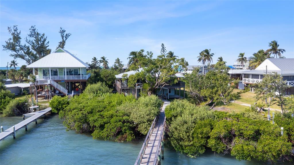 9776 Little Gasparilla Boca Grande, FL 33921 - Photo 7 of 52 an aerial view of a house with yard and outdoor seating