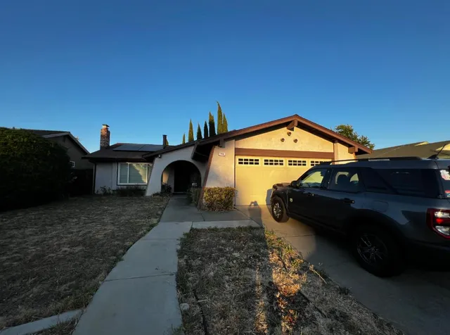 a view of a car in front of a house