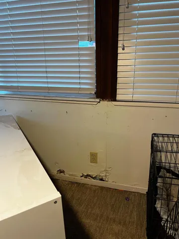 a view of a room with window and a door