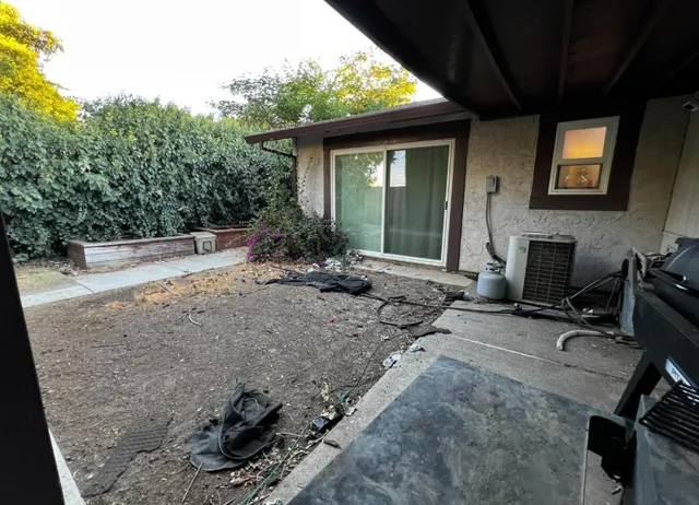 a view of a house with backyard and sitting area