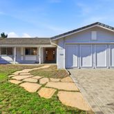 a front view of a house with yard patio and fire pit
