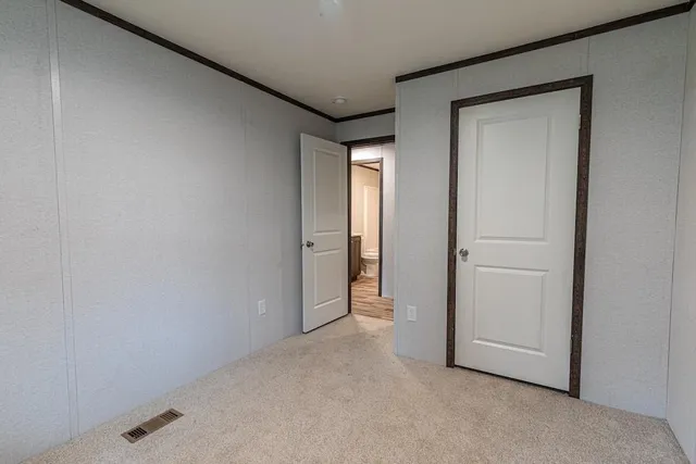 a view of an empty room and closet area