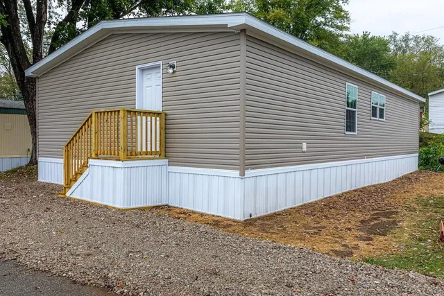 a view of a house with a backyard
