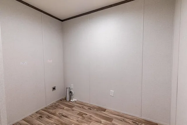 a room with a exposed radiator and wooden floor