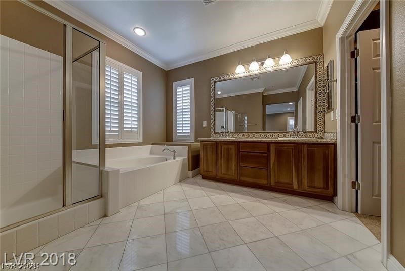 3144 Whitfeild Avenue Henderson, NV 89044 - Photo 22 of 55 A well-appointed bathroom offers a separate shower, a generous soaking tub, and an extended vanity with abundant storage.