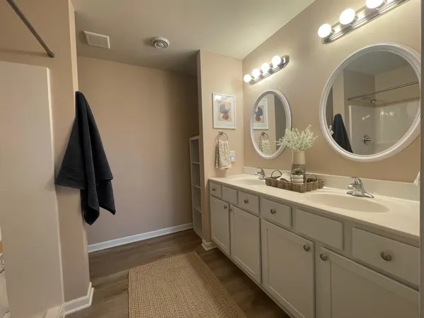 a bathroom with a double vanity sink and a mirror
